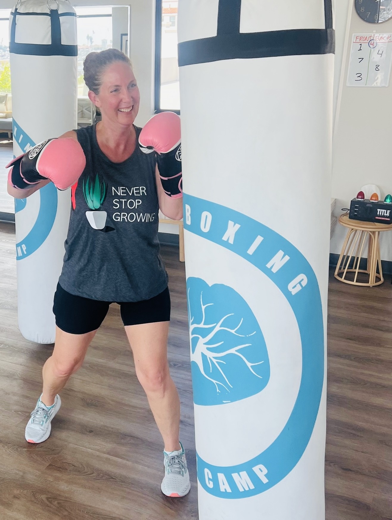 Boxer training with pink gloves at Portside Fitness.